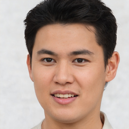 Joyful asian young-adult male with short  brown hair and brown eyes