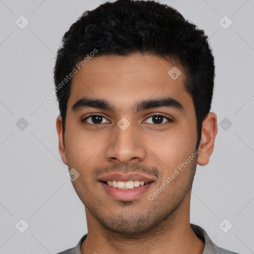 Joyful latino young-adult male with short  black hair and brown eyes