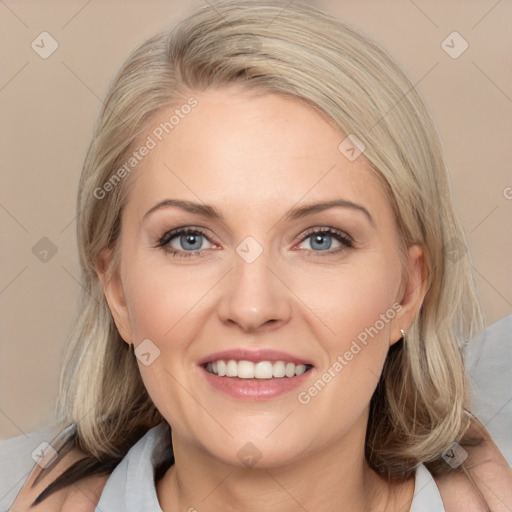 Joyful white adult female with medium  brown hair and blue eyes