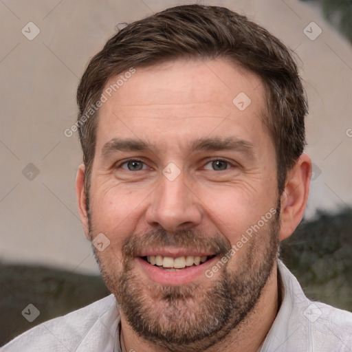 Joyful white adult male with short  brown hair and brown eyes