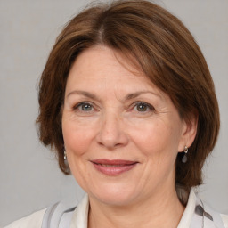 Joyful white adult female with medium  brown hair and brown eyes