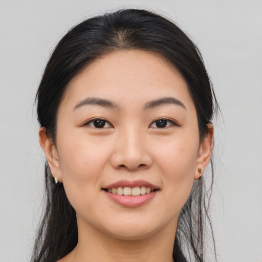Joyful asian young-adult female with medium  brown hair and brown eyes