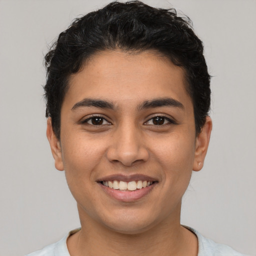 Joyful latino young-adult female with short  black hair and brown eyes