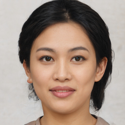 Joyful asian young-adult female with medium  black hair and brown eyes