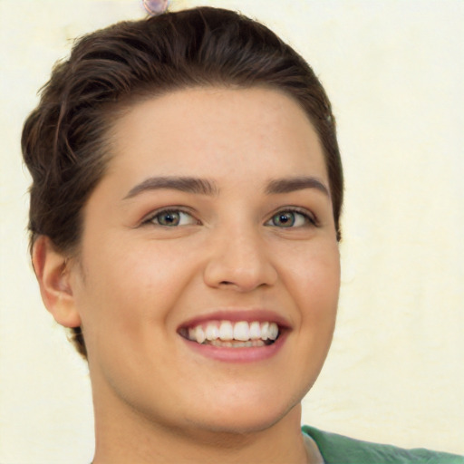 Joyful white young-adult female with short  brown hair and green eyes