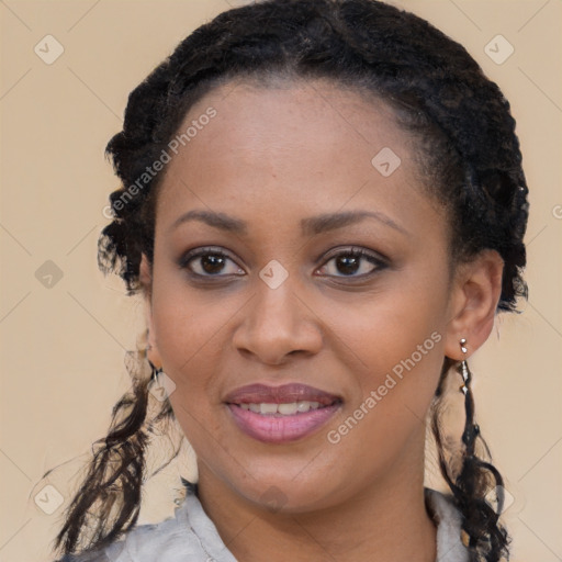 Joyful black young-adult female with long  brown hair and brown eyes