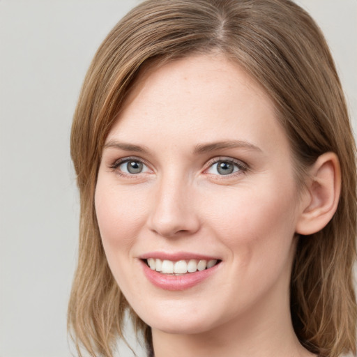 Joyful white young-adult female with medium  brown hair and blue eyes