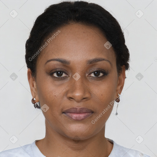 Joyful black adult female with short  brown hair and brown eyes