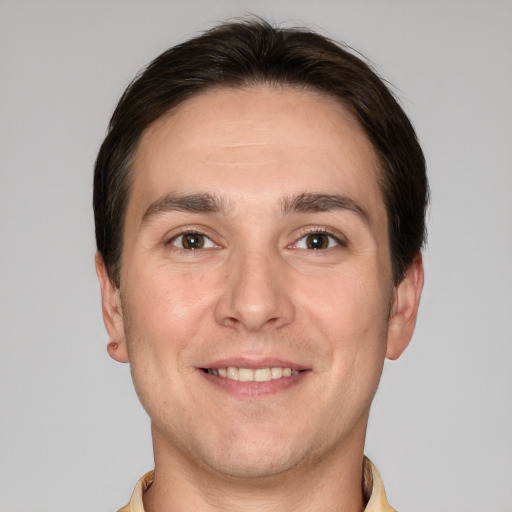 Joyful white young-adult male with short  brown hair and brown eyes