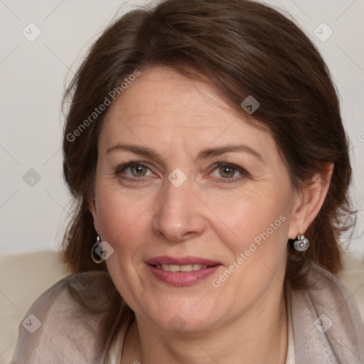 Joyful white adult female with medium  brown hair and blue eyes