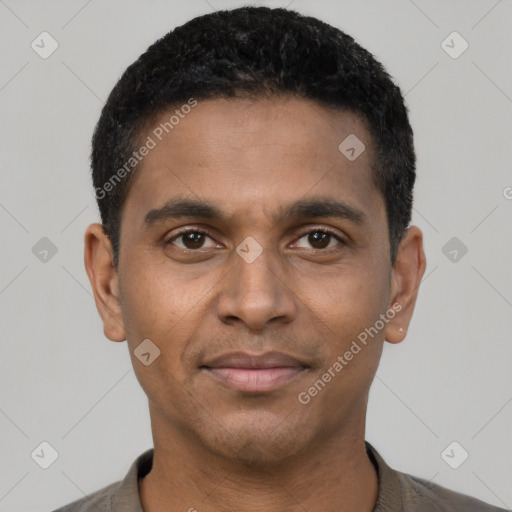 Joyful black young-adult male with short  black hair and brown eyes