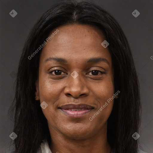 Joyful black adult female with long  brown hair and brown eyes