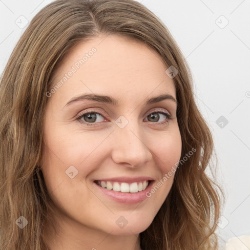 Joyful white young-adult female with long  brown hair and green eyes