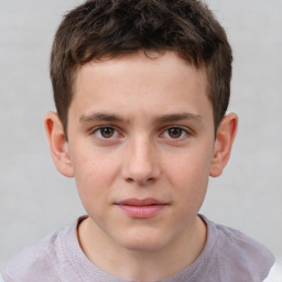 Joyful white child male with short  brown hair and brown eyes