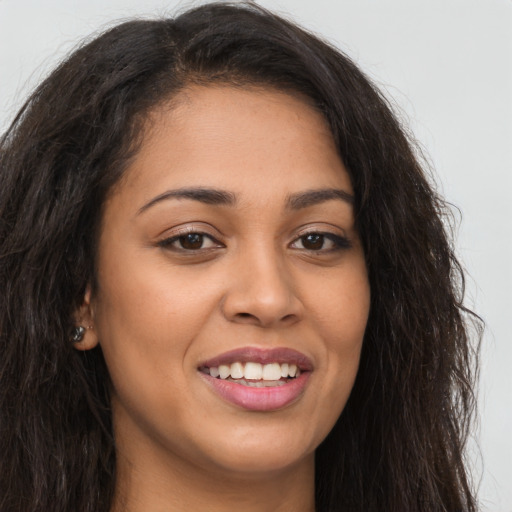 Joyful latino young-adult female with long  brown hair and brown eyes