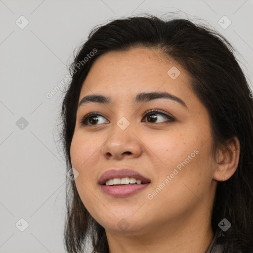 Joyful asian young-adult female with long  brown hair and brown eyes