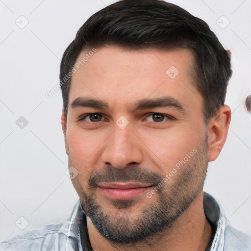 Joyful white young-adult male with short  black hair and brown eyes