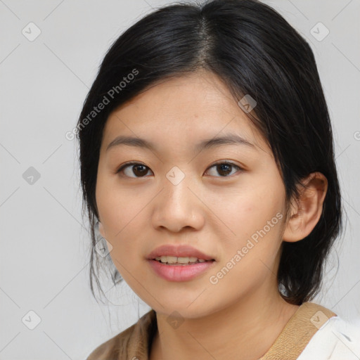 Joyful asian young-adult female with medium  black hair and brown eyes