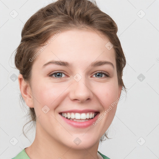 Joyful white young-adult female with medium  brown hair and green eyes