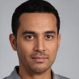 Neutral latino young-adult male with short  brown hair and brown eyes