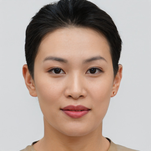Joyful asian young-adult female with short  black hair and brown eyes