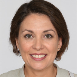 Joyful white adult female with medium  brown hair and brown eyes