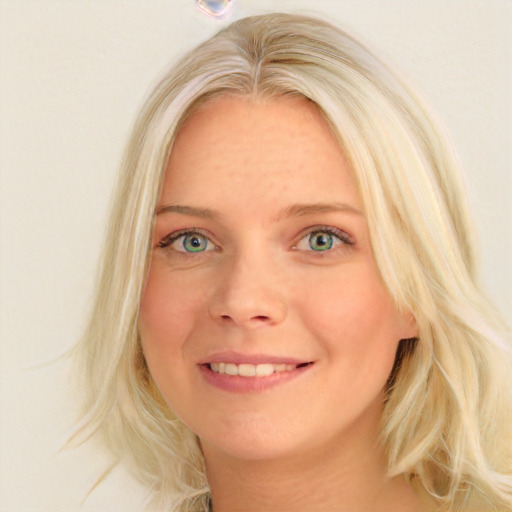 Joyful white young-adult female with long  blond hair and blue eyes