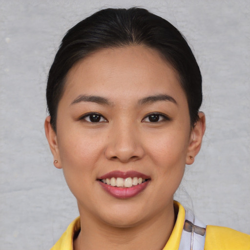 Joyful asian young-adult female with short  brown hair and brown eyes