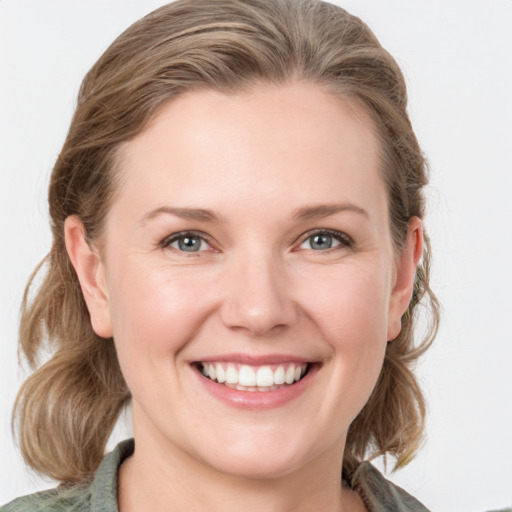 Joyful white young-adult female with medium  brown hair and blue eyes