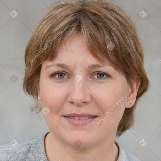 Joyful white adult female with medium  brown hair and blue eyes