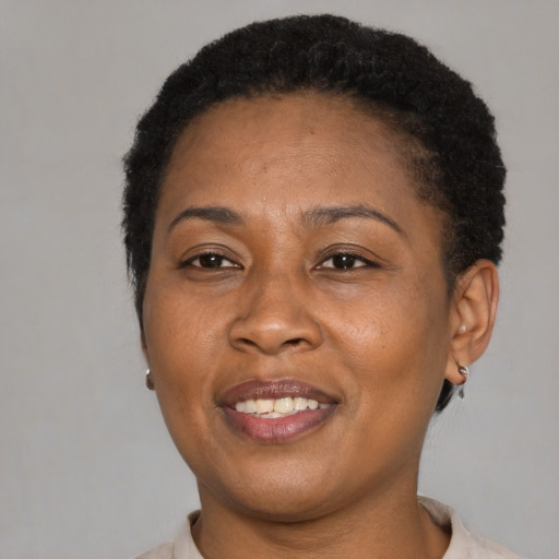 Joyful latino adult female with short  brown hair and brown eyes