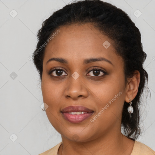 Joyful black young-adult female with long  brown hair and brown eyes