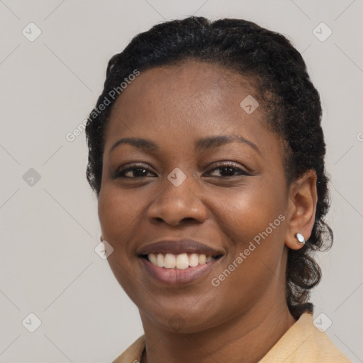 Joyful black young-adult female with long  black hair and brown eyes