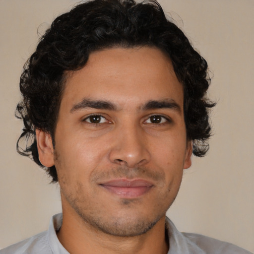 Joyful latino young-adult male with short  brown hair and brown eyes