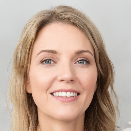 Joyful white young-adult female with long  brown hair and green eyes