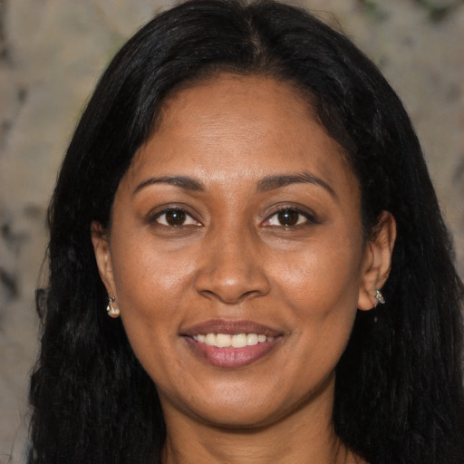 Joyful latino adult female with long  black hair and brown eyes