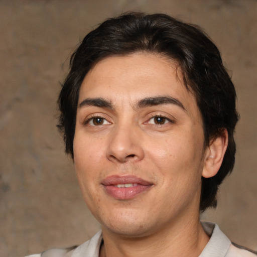 Joyful white adult male with medium  brown hair and brown eyes