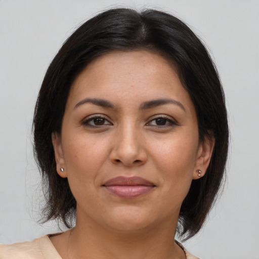 Joyful latino young-adult female with medium  brown hair and brown eyes