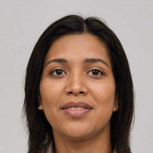 Joyful asian young-adult female with long  brown hair and brown eyes