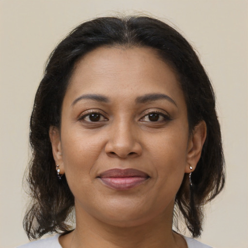 Joyful black young-adult female with medium  brown hair and brown eyes