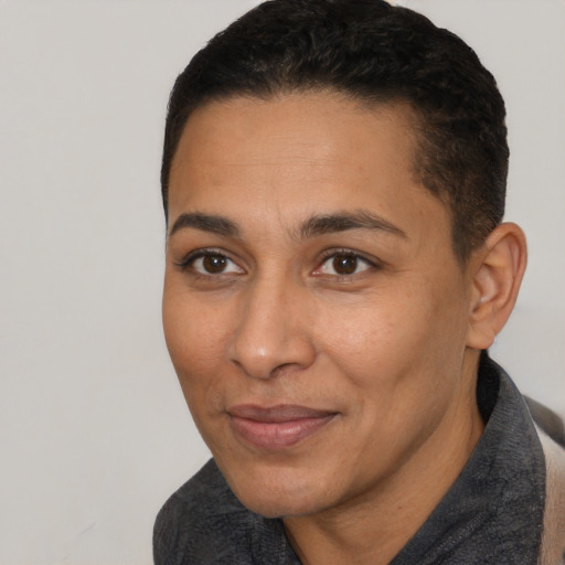 Joyful latino young-adult female with short  black hair and brown eyes