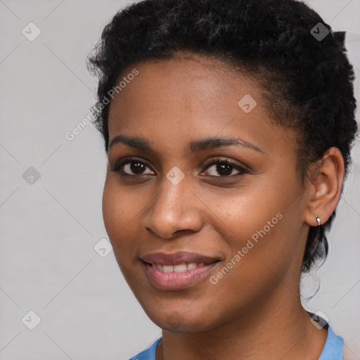 Joyful black young-adult female with short  black hair and brown eyes