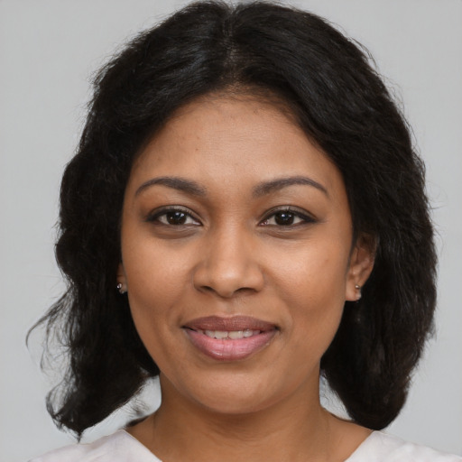 Joyful black young-adult female with medium  brown hair and brown eyes