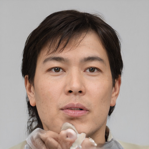 Neutral asian adult male with medium  brown hair and brown eyes