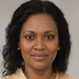 Joyful black adult female with medium  brown hair and brown eyes