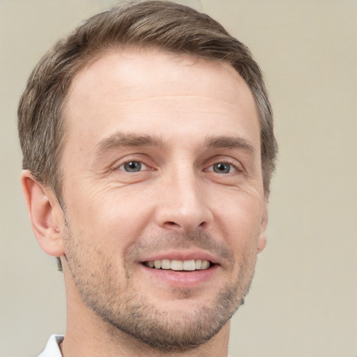 Joyful white adult male with short  brown hair and brown eyes