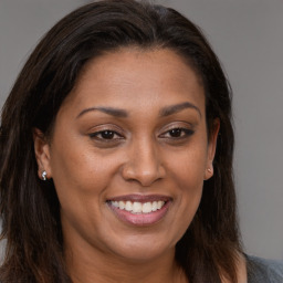 Joyful white adult female with long  brown hair and brown eyes