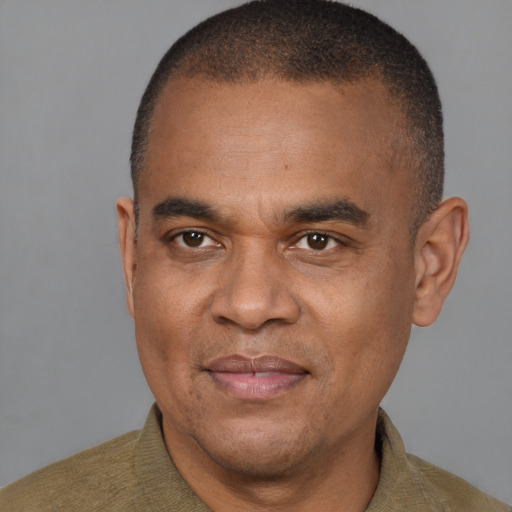 Joyful black adult male with short  brown hair and brown eyes