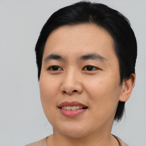 Joyful asian young-adult male with medium  black hair and brown eyes