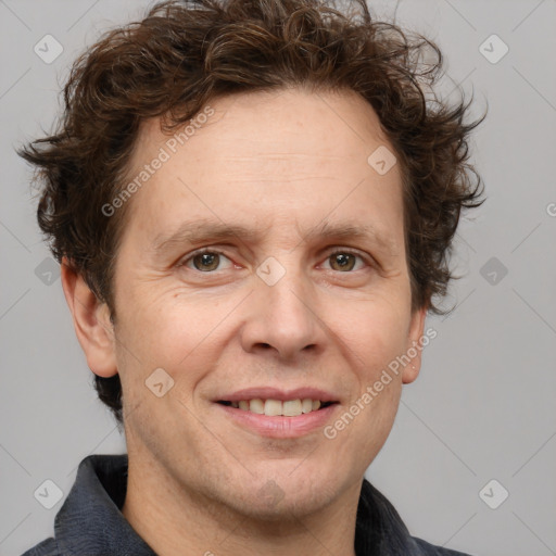 Joyful white adult male with short  brown hair and grey eyes